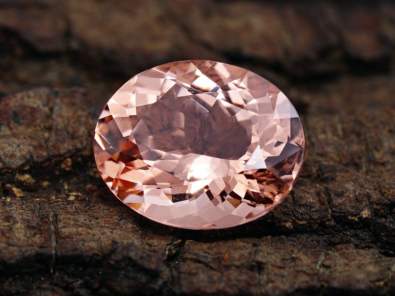 morganite gemstone on brown background