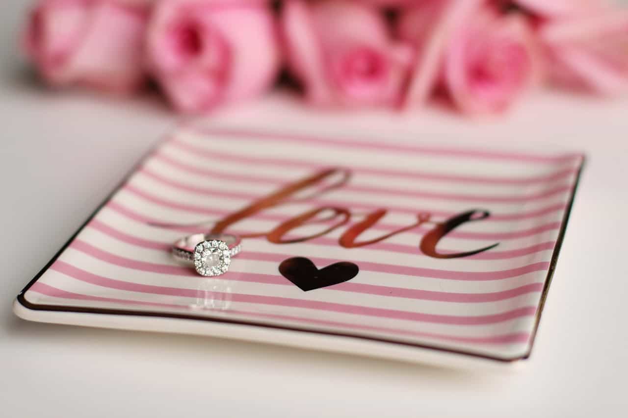 Engagement ring on a pink plate