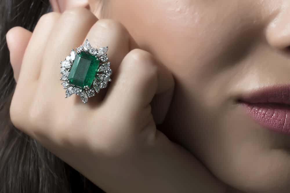 emerald ring on girl's finger