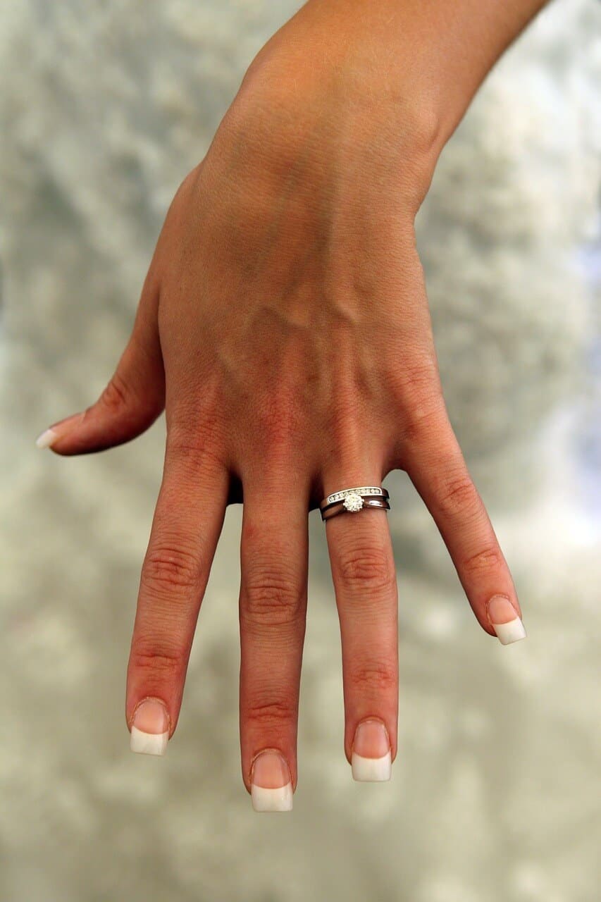  engagement  ring  and wedding  band  on woman left finger  
