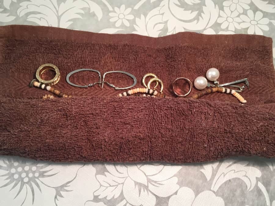 rolling jewelry in towel for packing jewelry