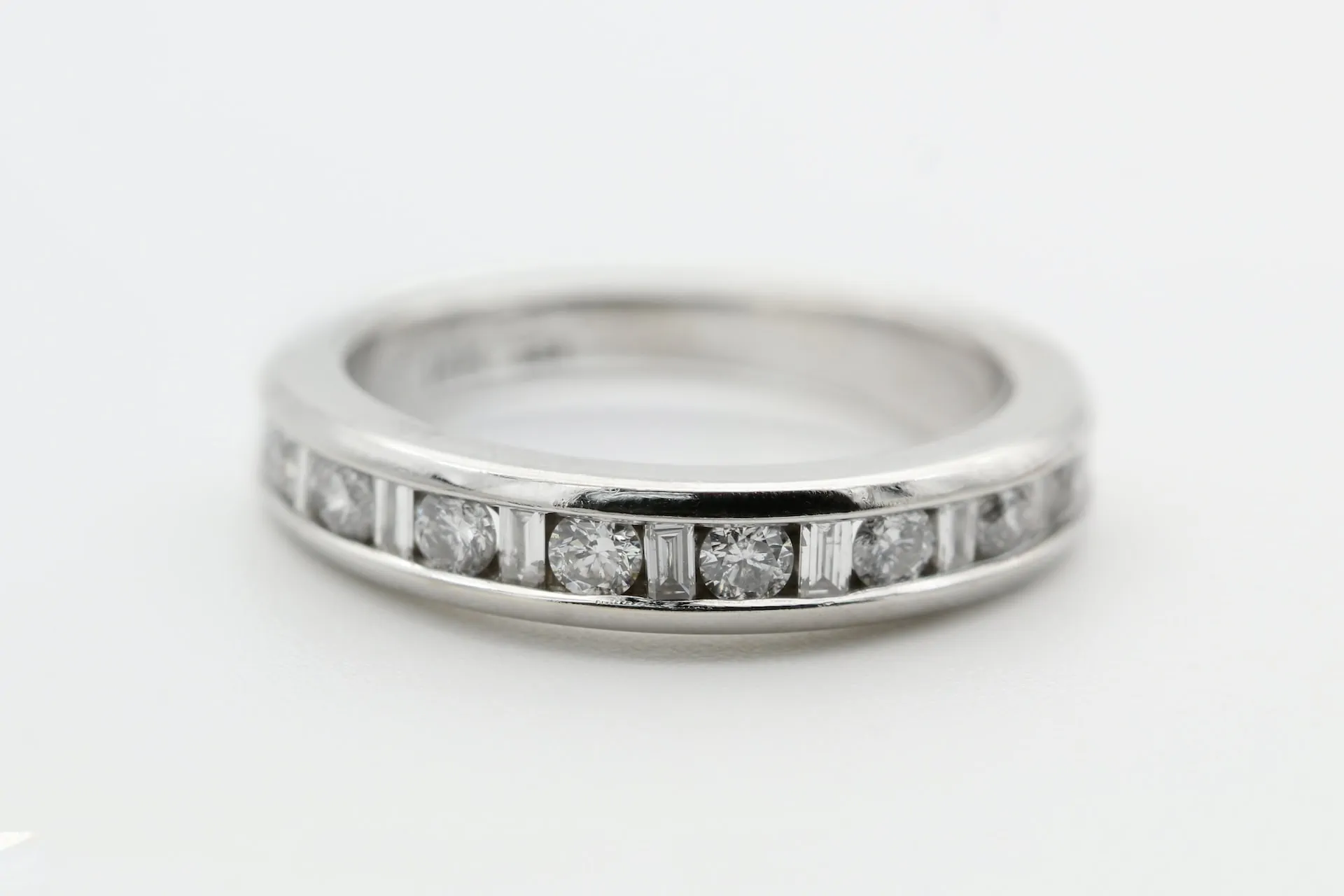 rhodium plated ring on grey background