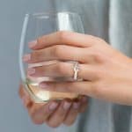 Wide band engagement ring on a womans finger