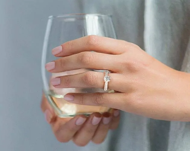 Wide band engagement ring on a womans finger