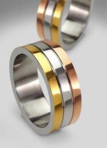 three metal wedding rings