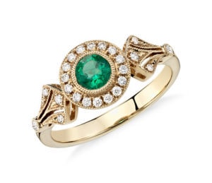 Green emerald and diamond engagement ring