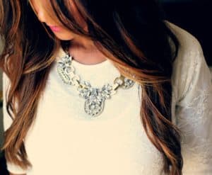 Plus size woman wearing statement necklace