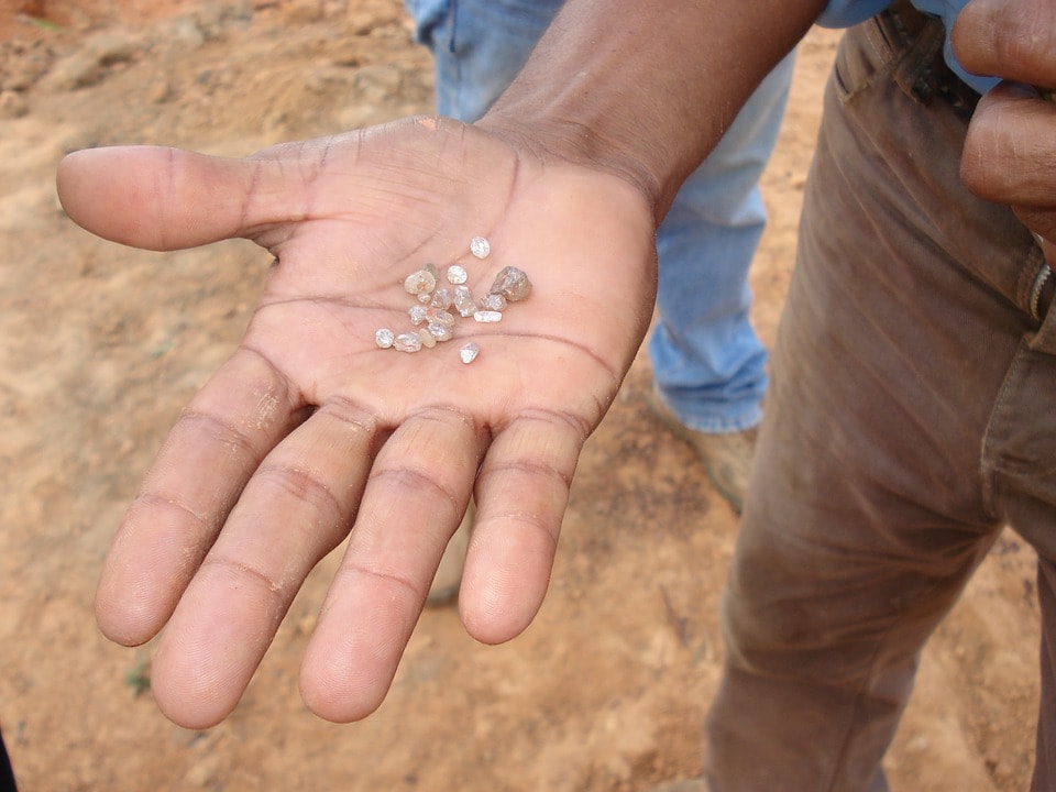 Rough diamonds in the hand of a miner