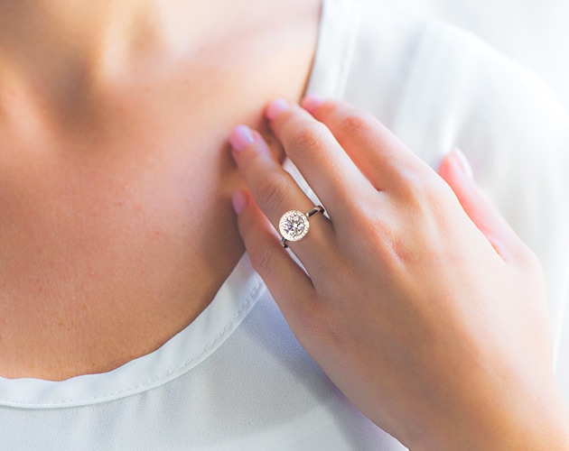 Large round shape diamond engagement ring on girls finger