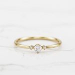 minimalist engagement ring with round shape diamond in yellow gold