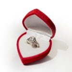 Engagement ring on red box with round shape diamond
