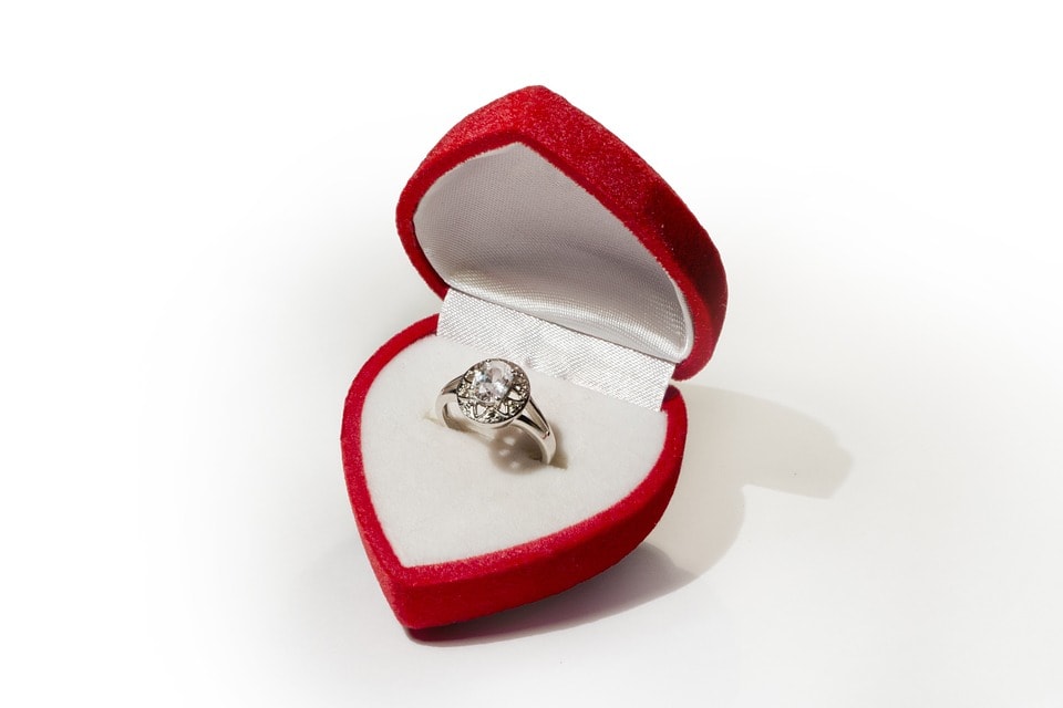Engagement ring on red box with round shape diamond