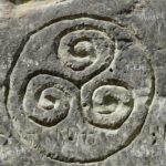 Triskelion symbol rock carving
