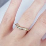 Diamond wishbone ring on her finger