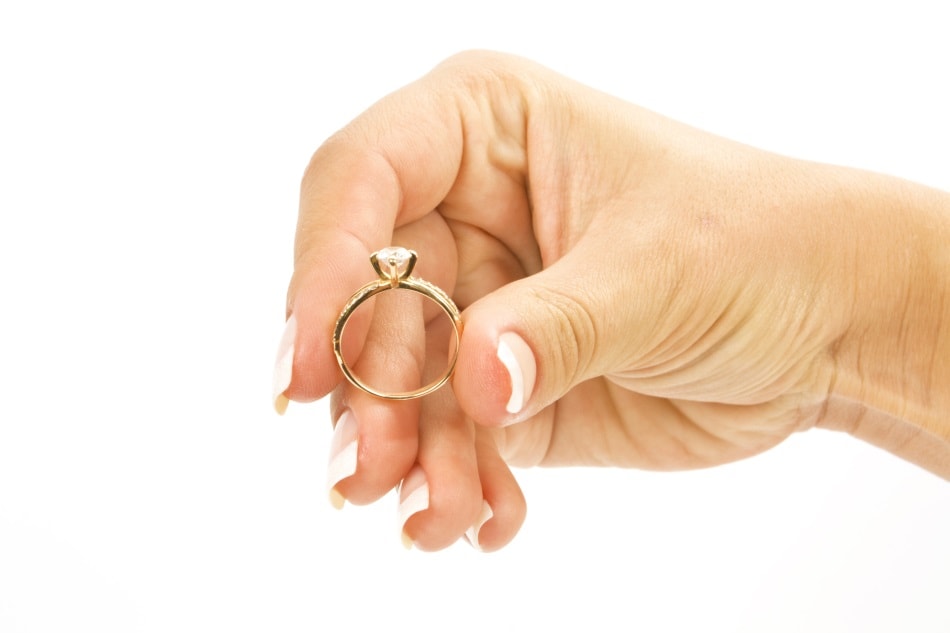 Woman's hand holding engagement ring