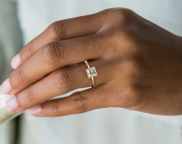 Milgrain thin width engagement ring on woman's finger