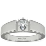 Wide engagement ring with pear shape diamond