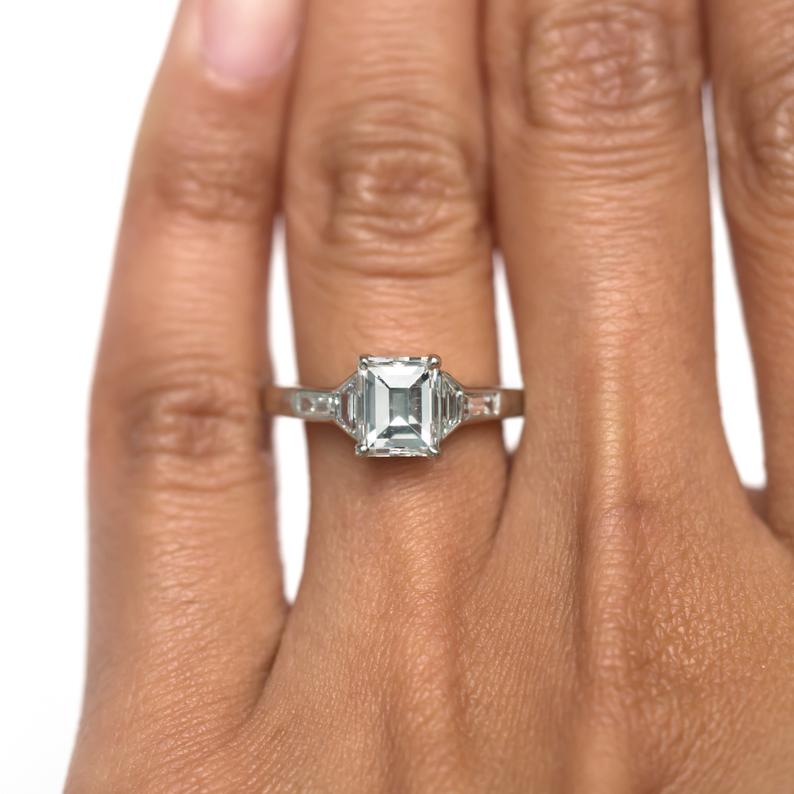 carre diamond ring on finger closeup