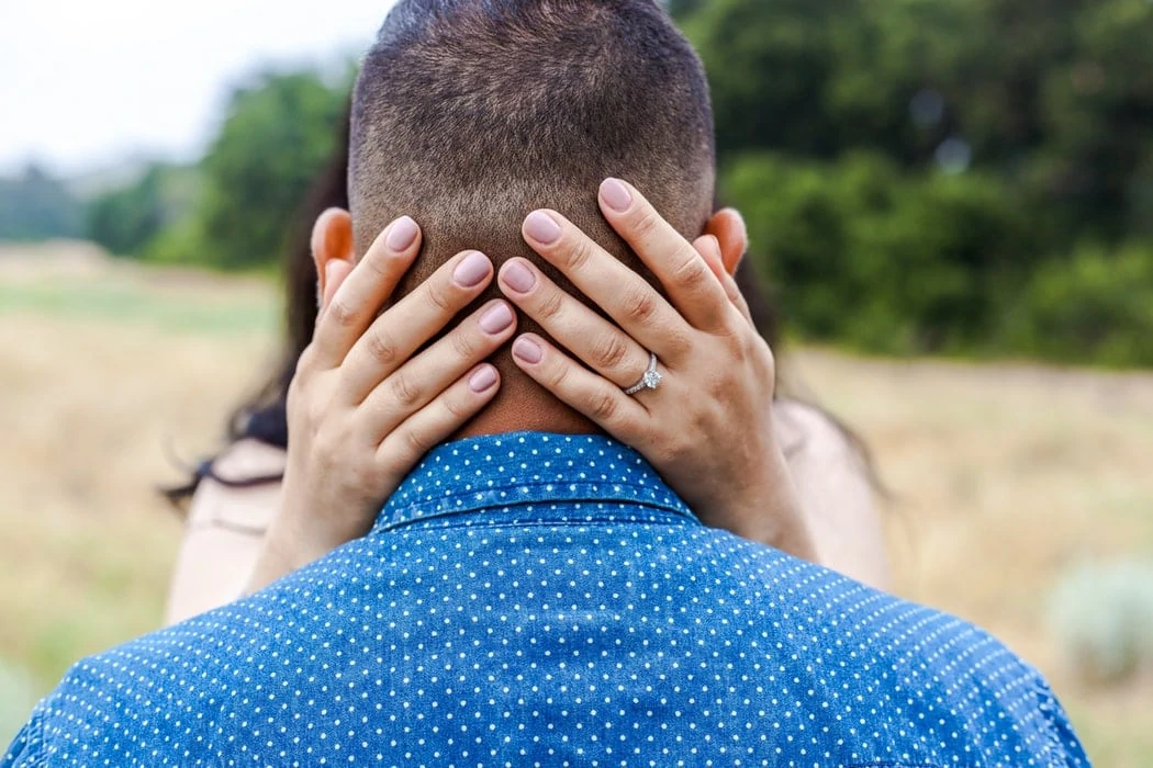 Bride with chubby fingers wearing engagement ring