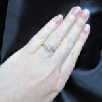 Halo Edwardian ring on her finger