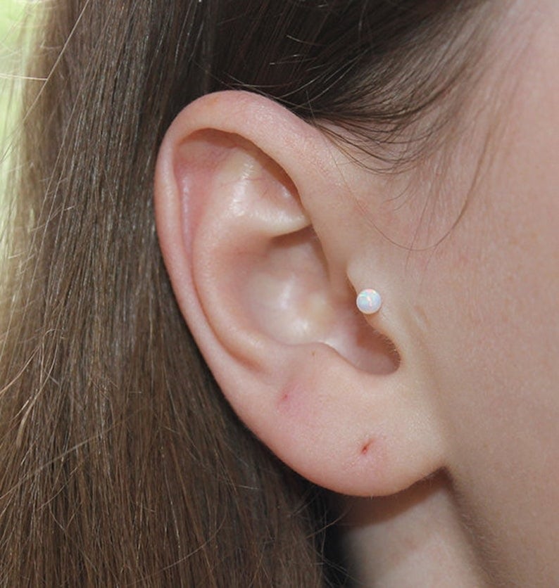 Opal stud om girl's ear