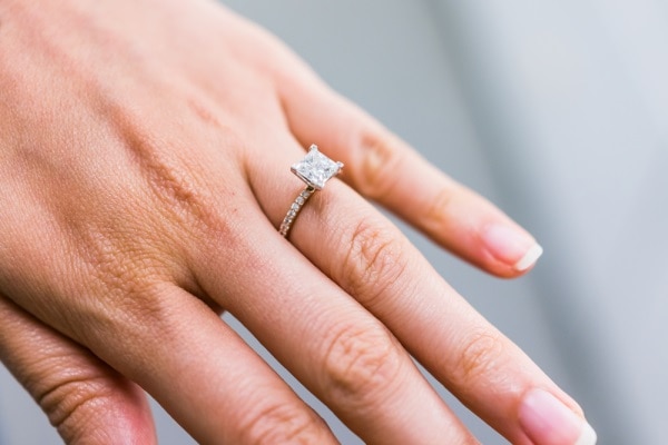 Princess cut diamond engagement ring on girl's finger