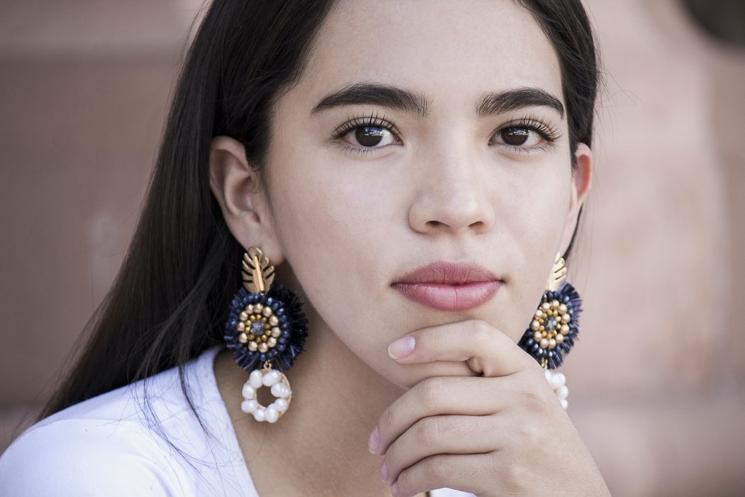 Girl wearing double sided earrings
