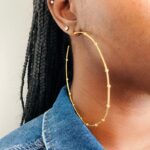 Girl with oversized hoop earrings
