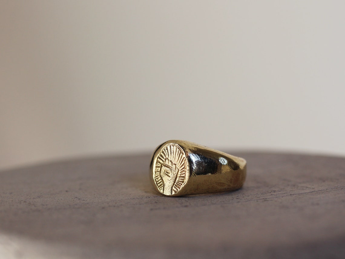 Raised fist signet ring