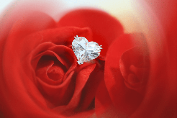 heart diamond ring on red background
