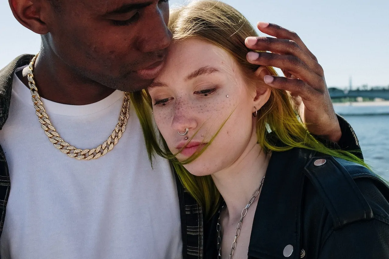 girl and boy wearing gold chains standing close