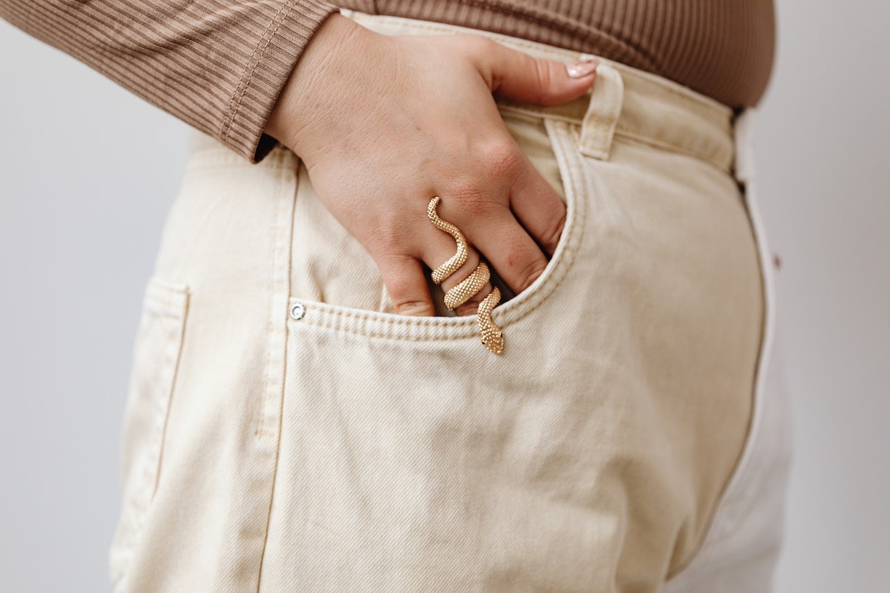 woman with snake ring hand in pocket