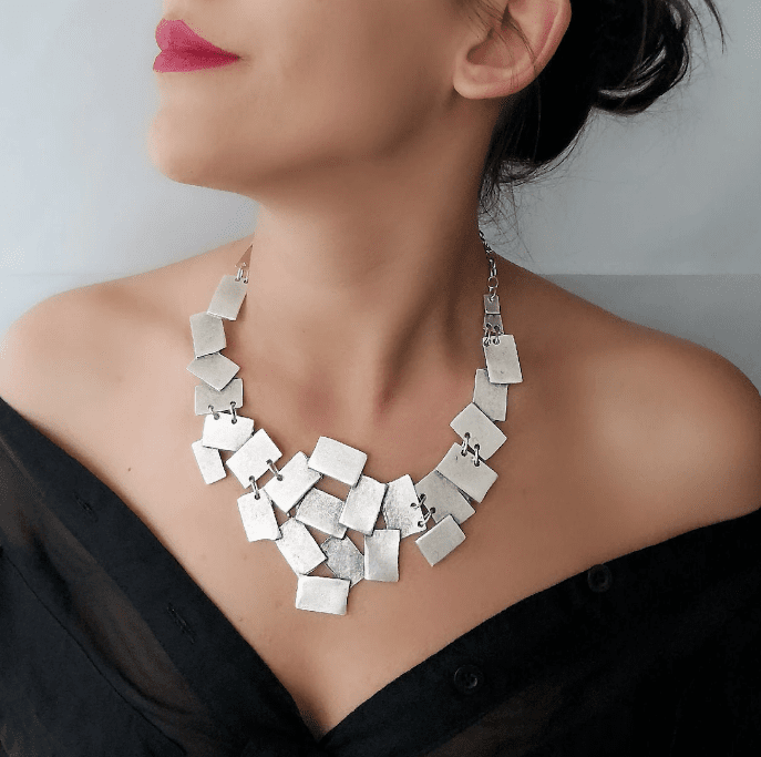 large silver necklace on woman