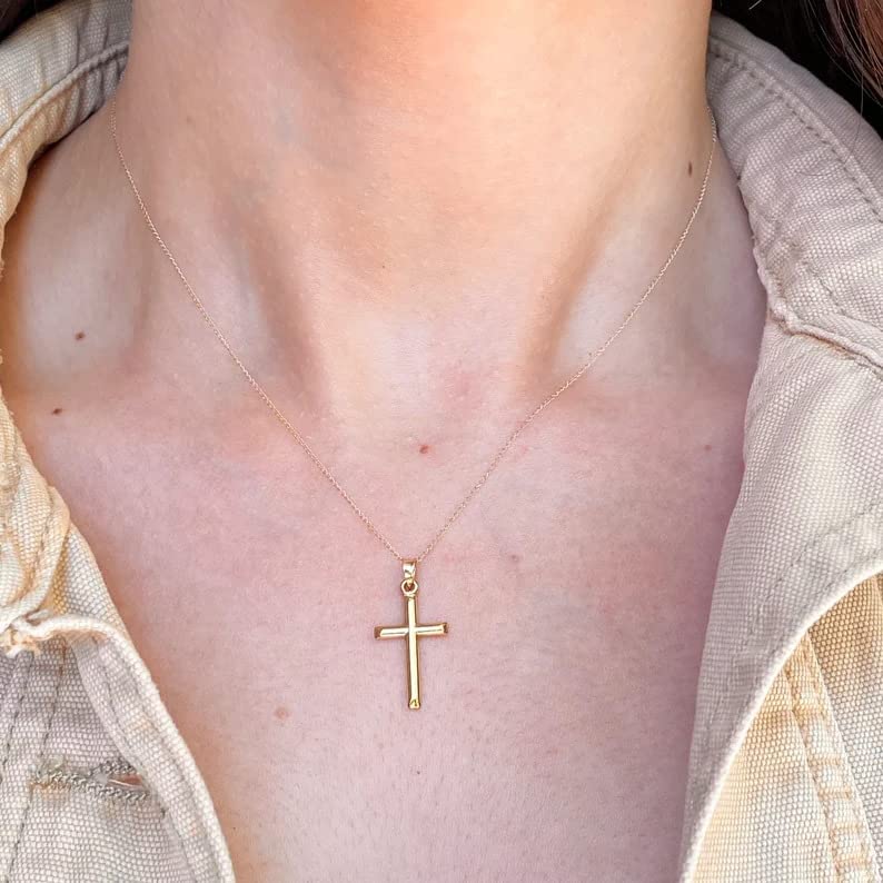 a woman wearing latin cross necklace