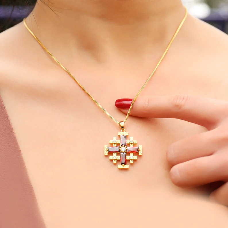 a woman wearing jerusalem cross necklace