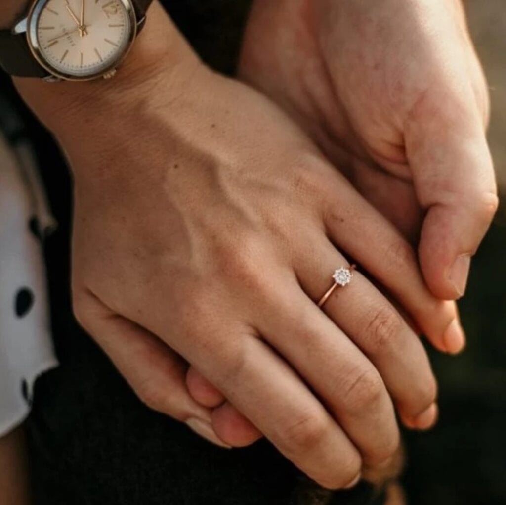 hands with an engagement ring