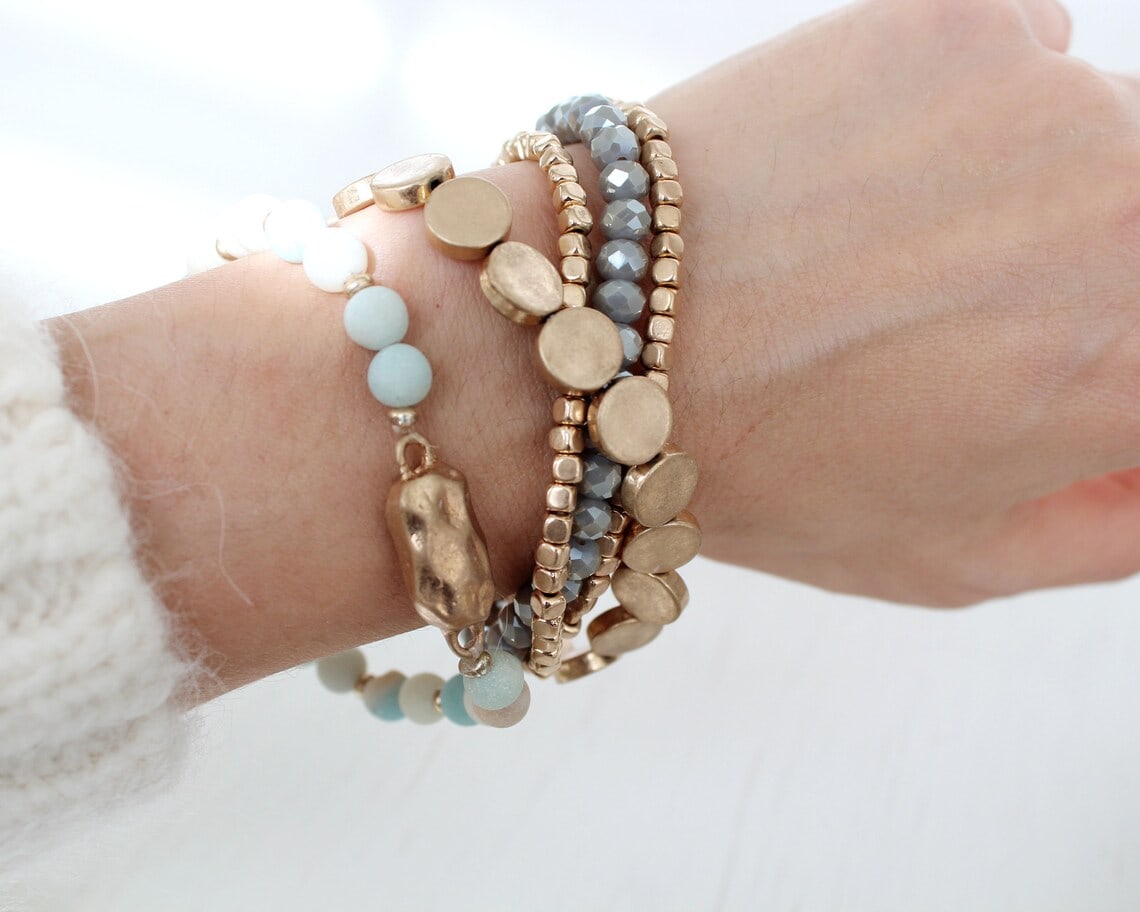 girl wearing different textured bracelets