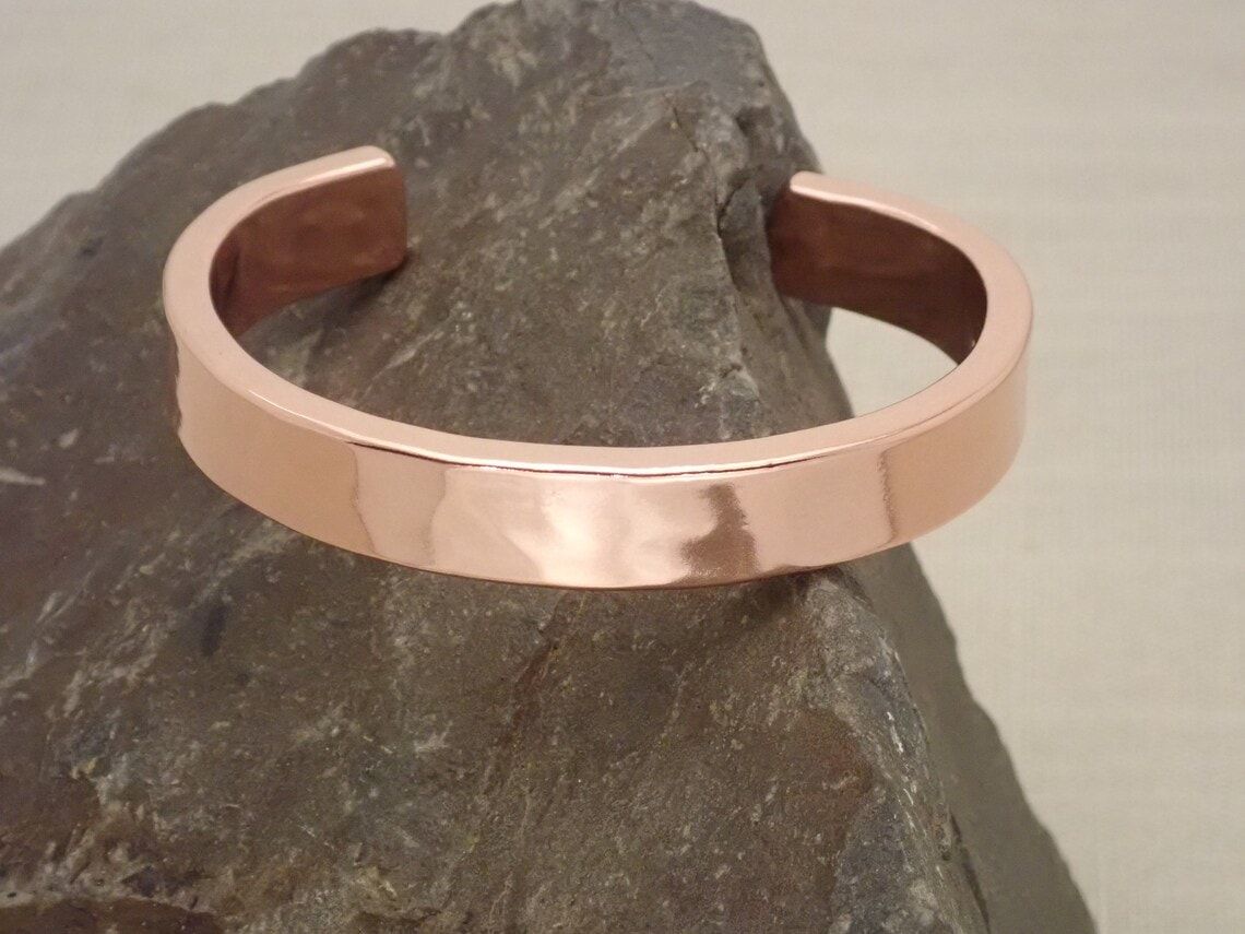copper cuff bracelet on rock