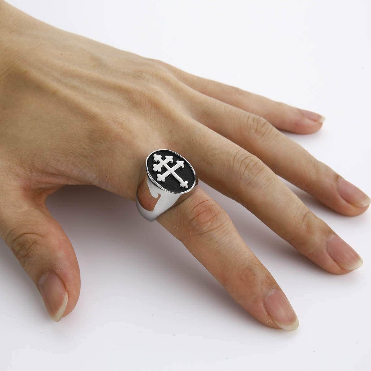 a hand with a cross of lorraine ring