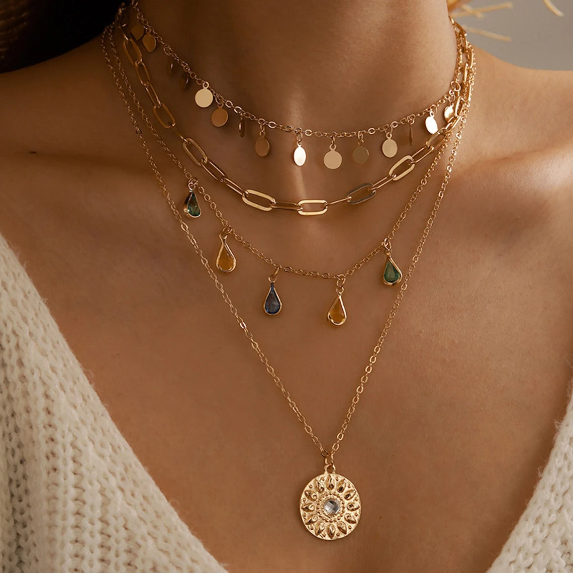 layers of necklaces with gemstones