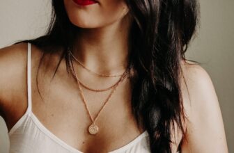 woman wearing layers of necklaces