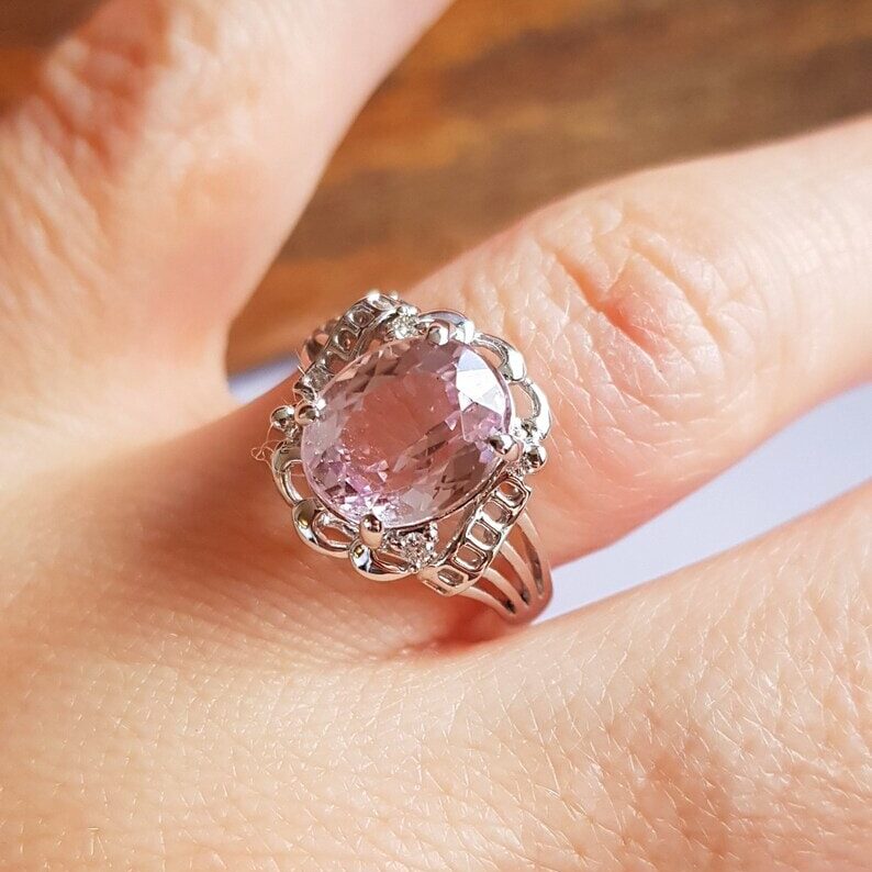 a hand with pink fluorite ring