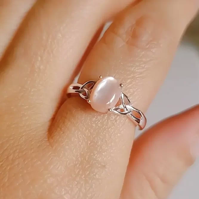 wearing a pink mother of pearl ring