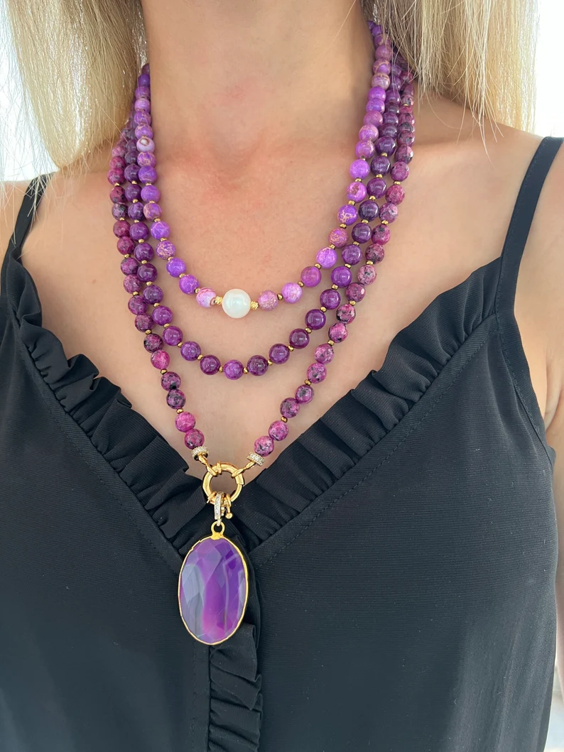 a woman wearing a purple agate necklace