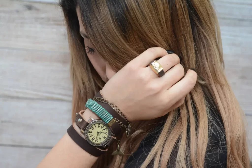 woman wearing bracelets made of leather with watch