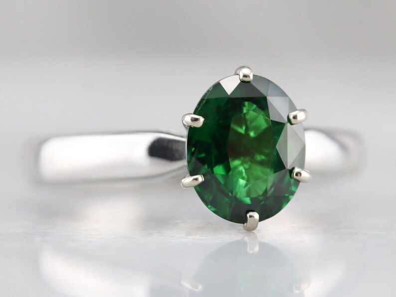 green gemstone in silver setting