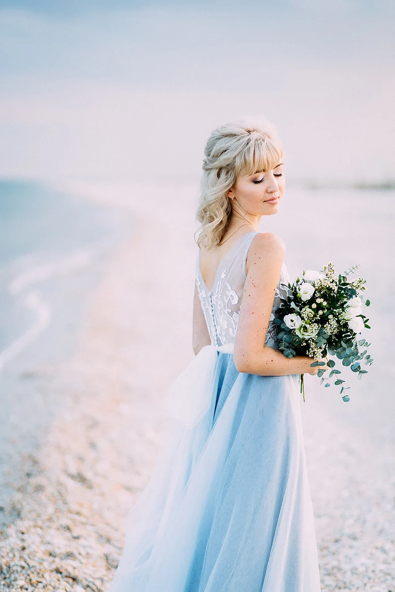a woman wearing blue boho wedding dress
