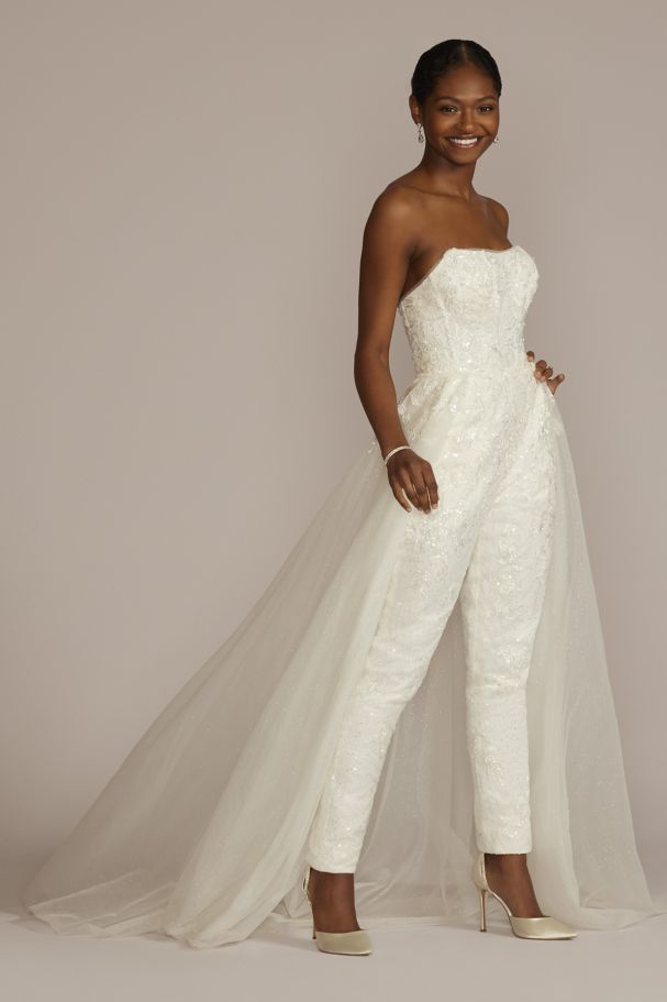 a woman wearing an embellished bridal jumpsuit with overskirt
