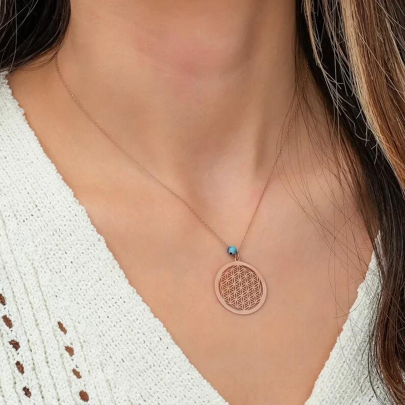 flower of life necklace in rose gold on a woman's neck