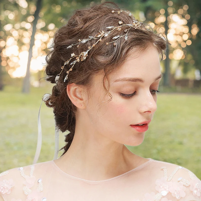 a girl wearing a gold leaf wedding tiara